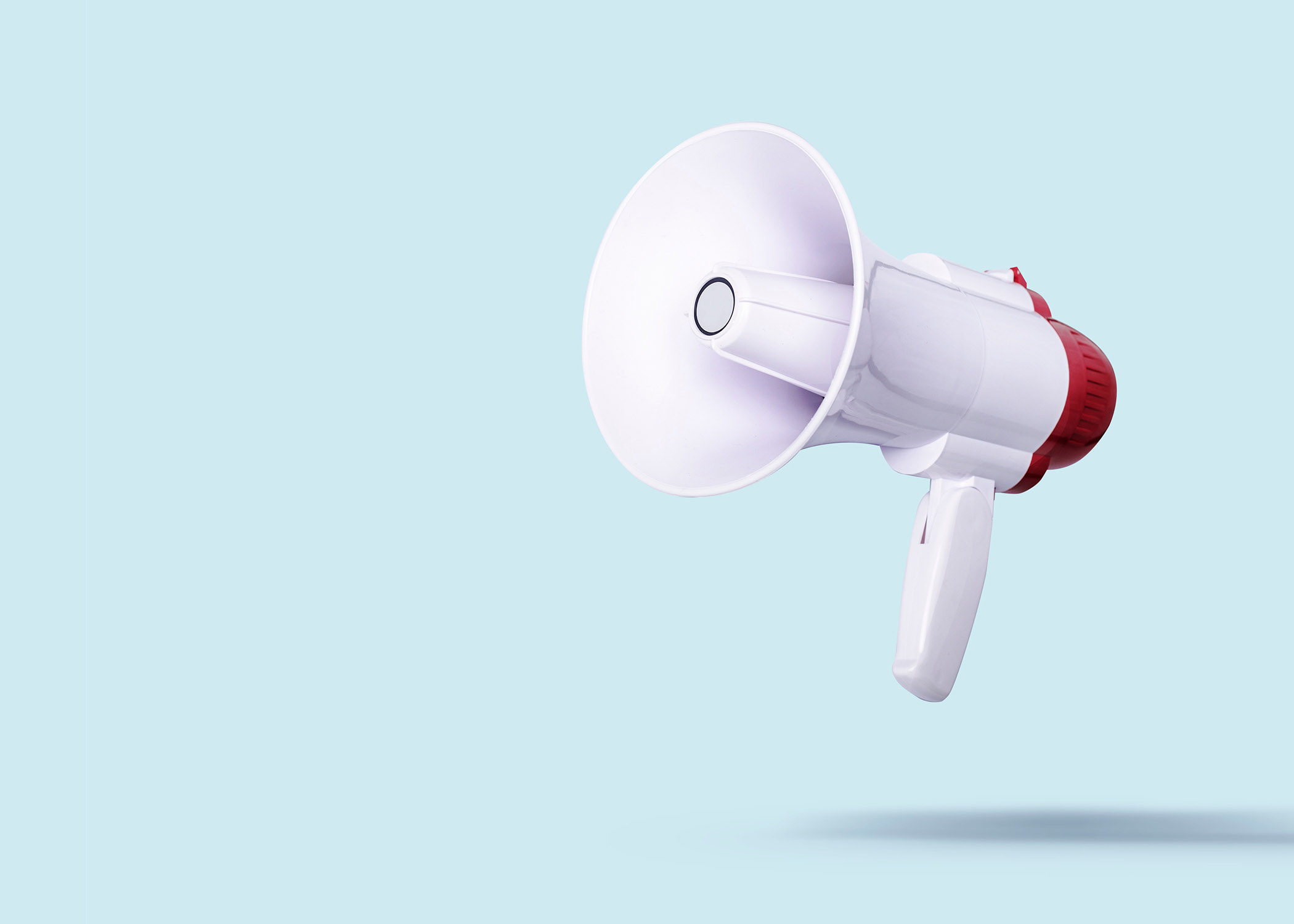 white megaphone flies on a light background. Advertising and messages concept. Banner.